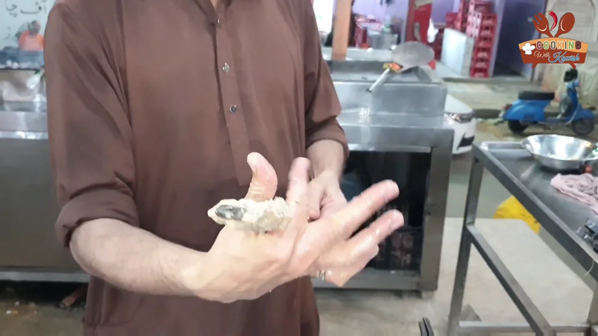 Shaping the chilled chicken mince onto a skewer