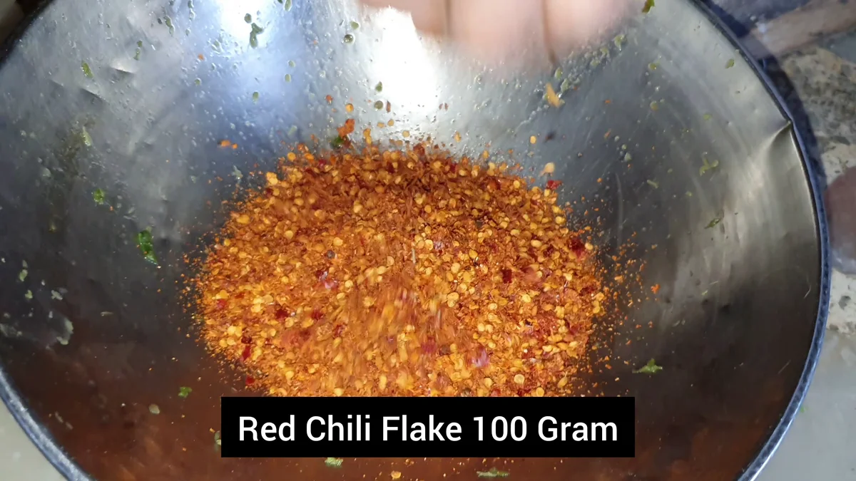 Red chilli flakes added to the wok