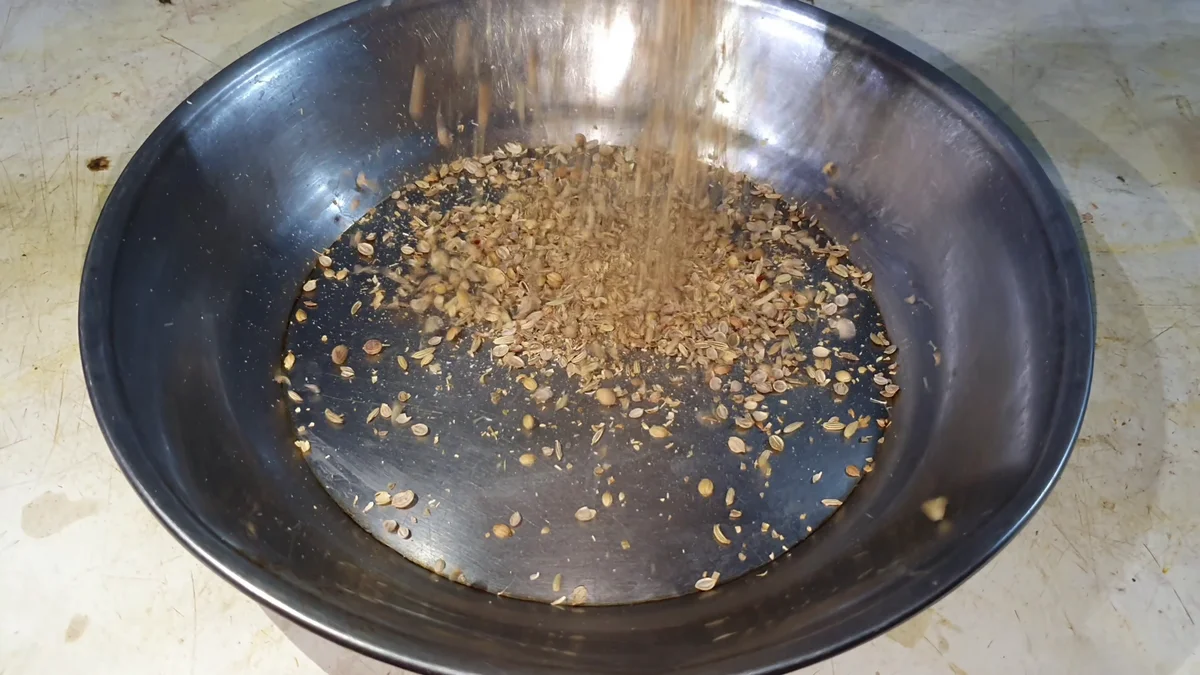 Crushed spices in a steel bowl for the pulao