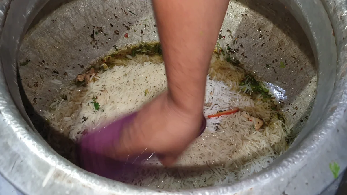 Rice being spread evenly over the gravy
