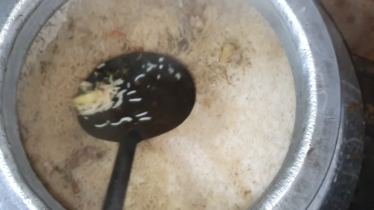 Rice being turned gently with a ladle