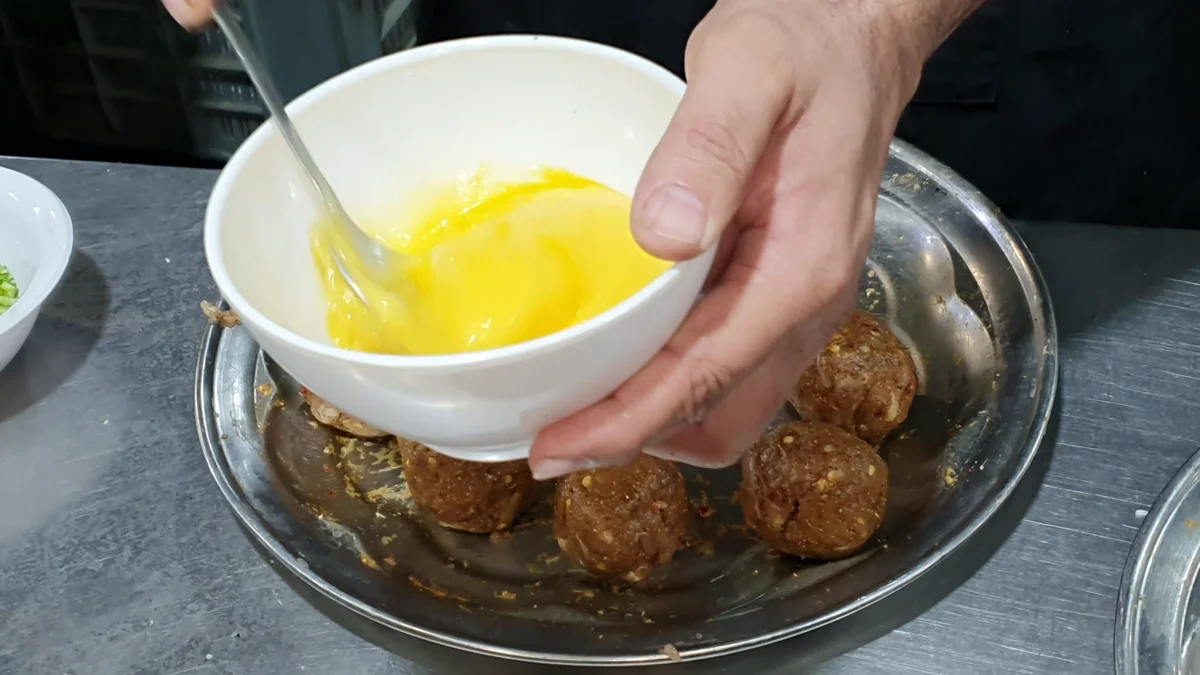 Beaten egg for dipping the chicken balls