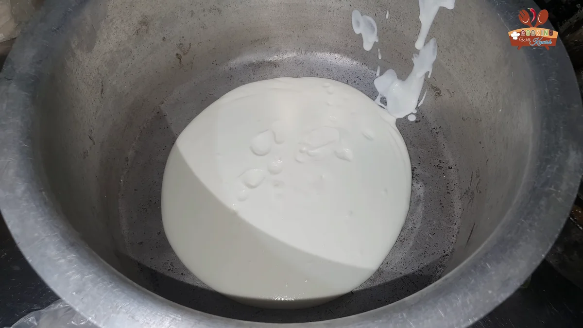 Yogurt being whisked in a large pot