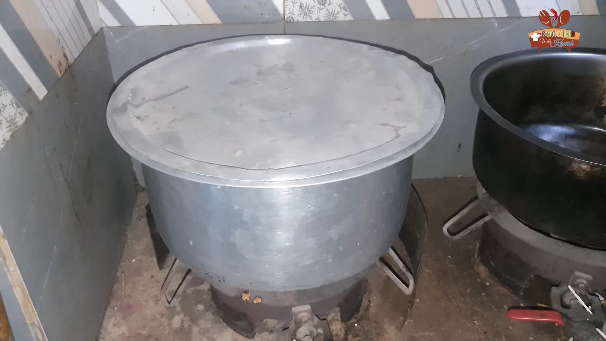 Pot covered while the mutton cooks on a very low flame