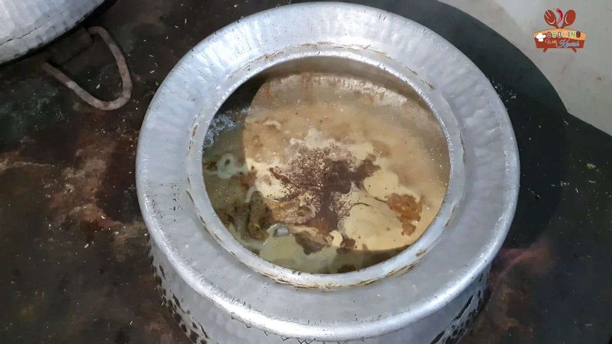 Ground spice powder being added to the korma
