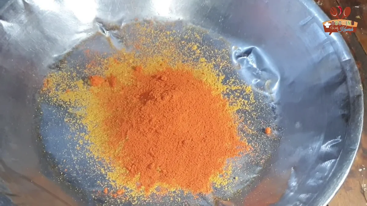 Red chilli powder, turmeric and other korma spices on a tray