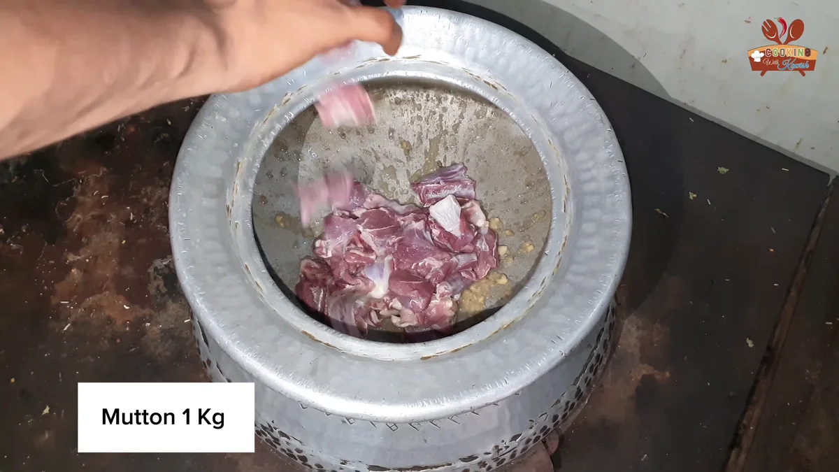 Mutton one kilo and onion slices going into the deg
