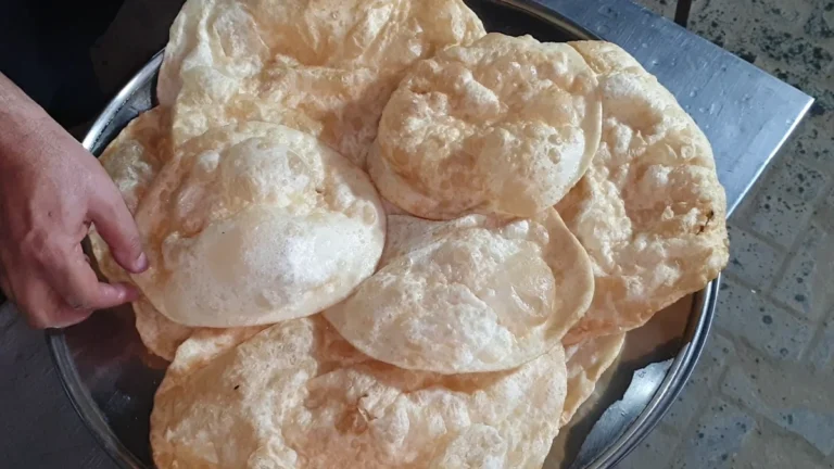 Stack of puffed Dua Restaurant poori parathas