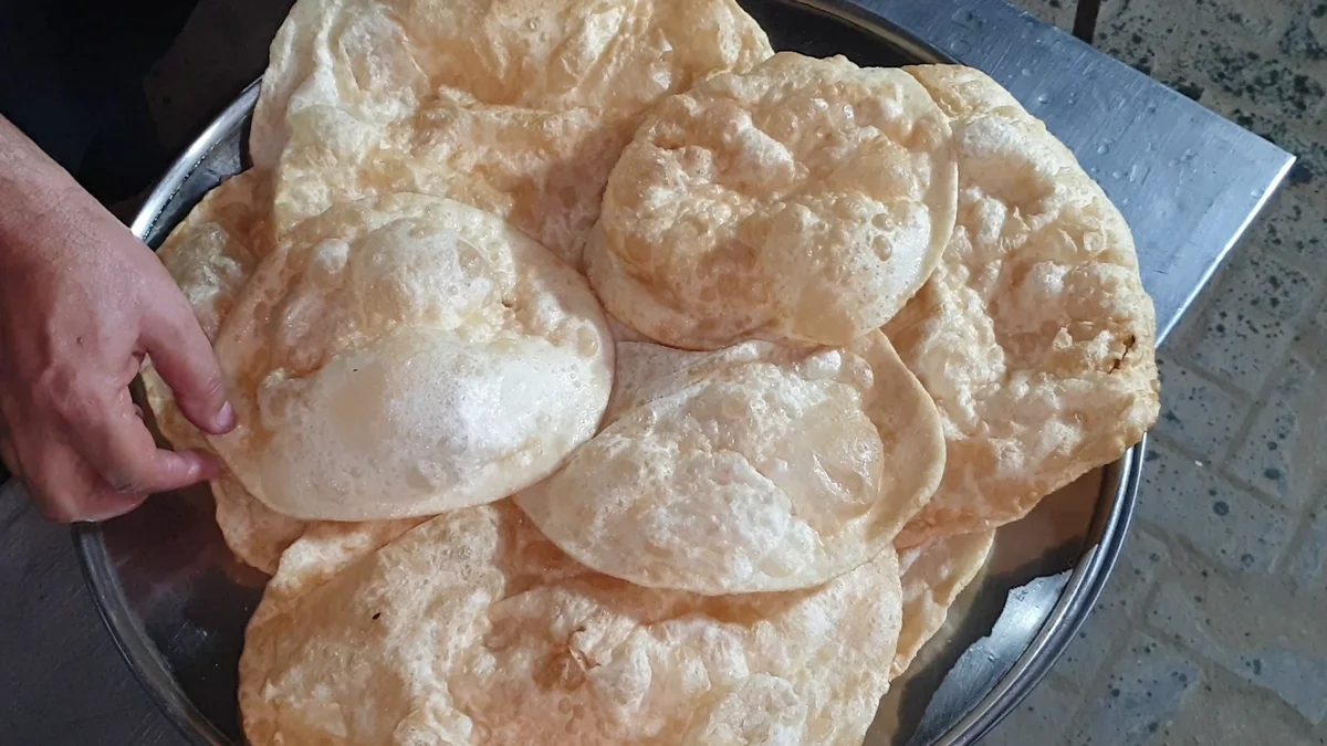 Stack of puffed Dua Restaurant poori parathas