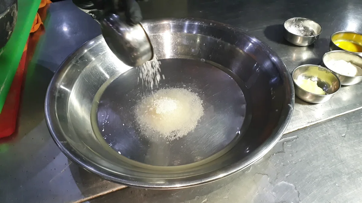 Maida flour in a large steel bowl