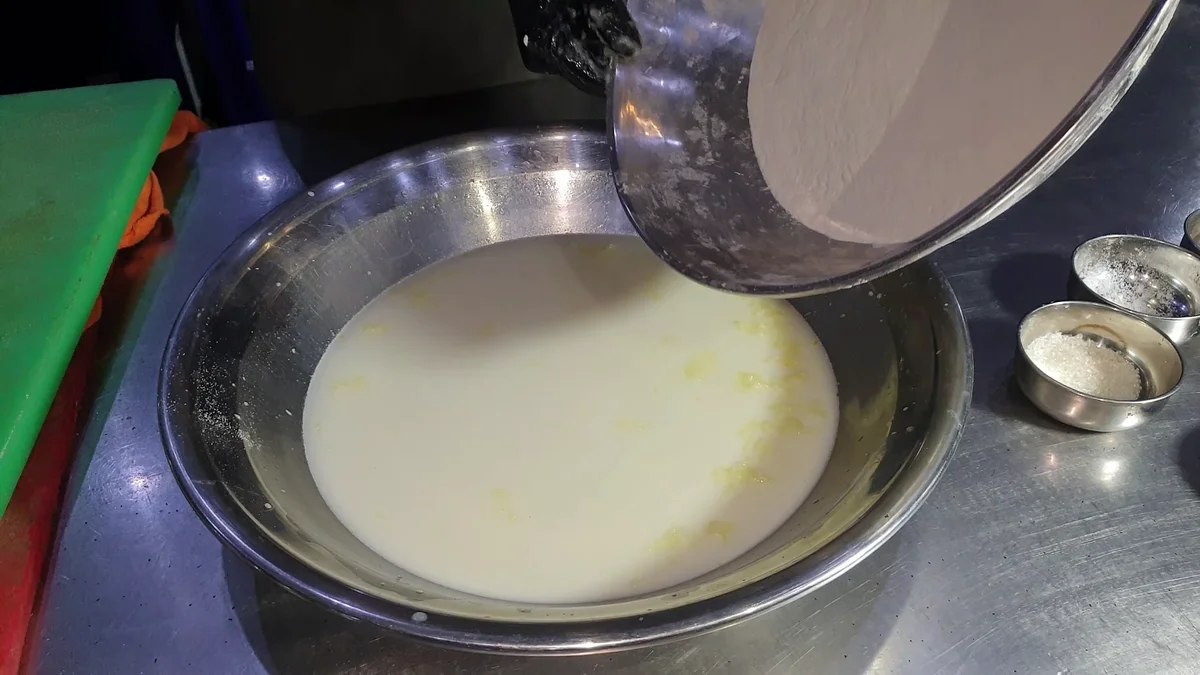 Liquid poured into the flour for the poori paratha dough