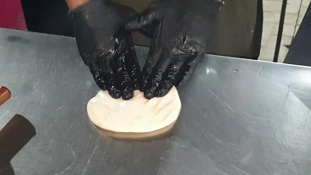Pressing a dough ball flat
