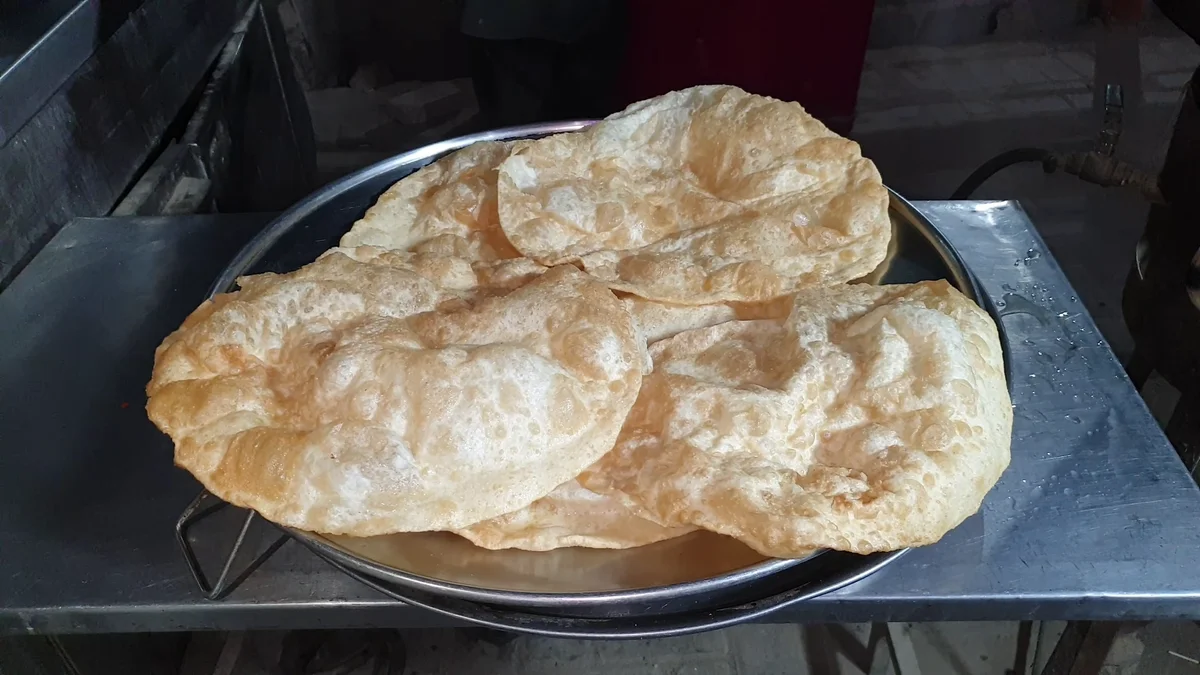 Fried poori parathas on a tray