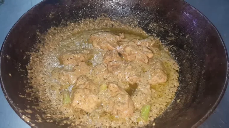 Creamy green chicken karahi ready in a steel karahi