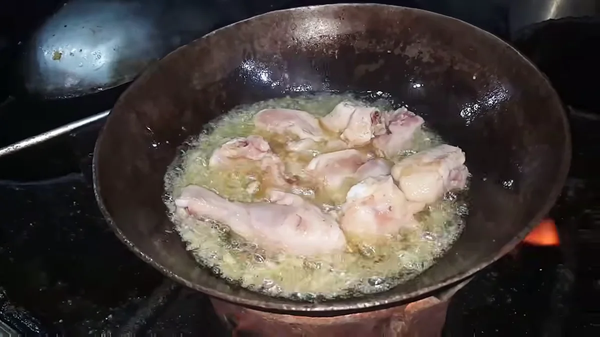 Chicken frying in the karahi until it changes colour