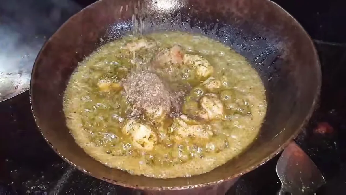 Ground pepper and cumin added to the karahi