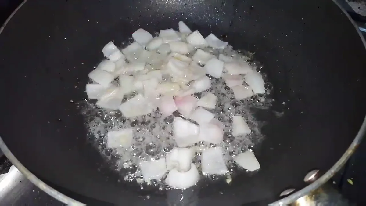 Onion cubes frying in the pan
