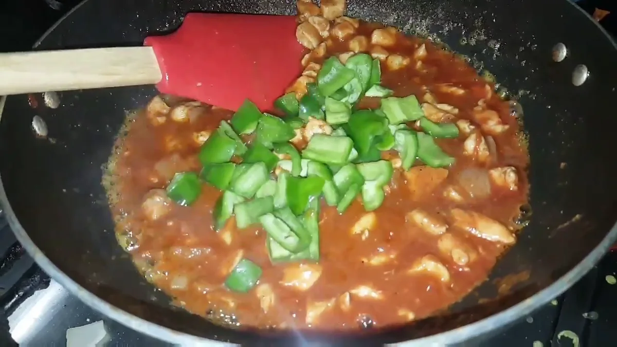 Chopped capsicum added to the chicken masala