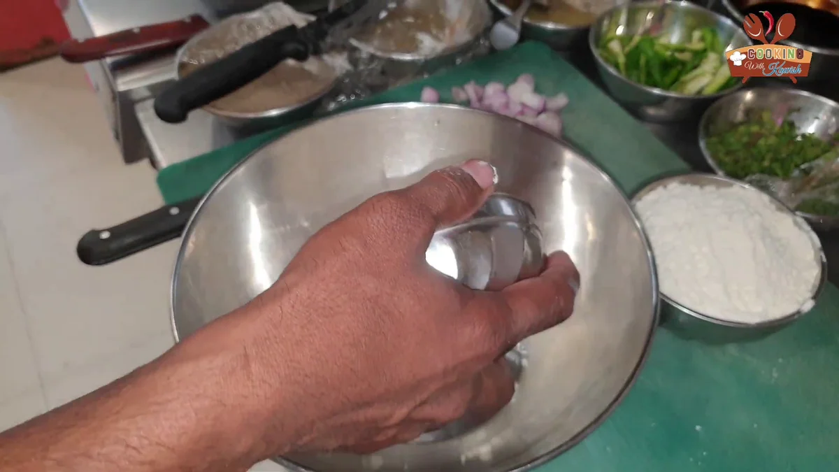 Cornflour being added to a steel mixing bowl