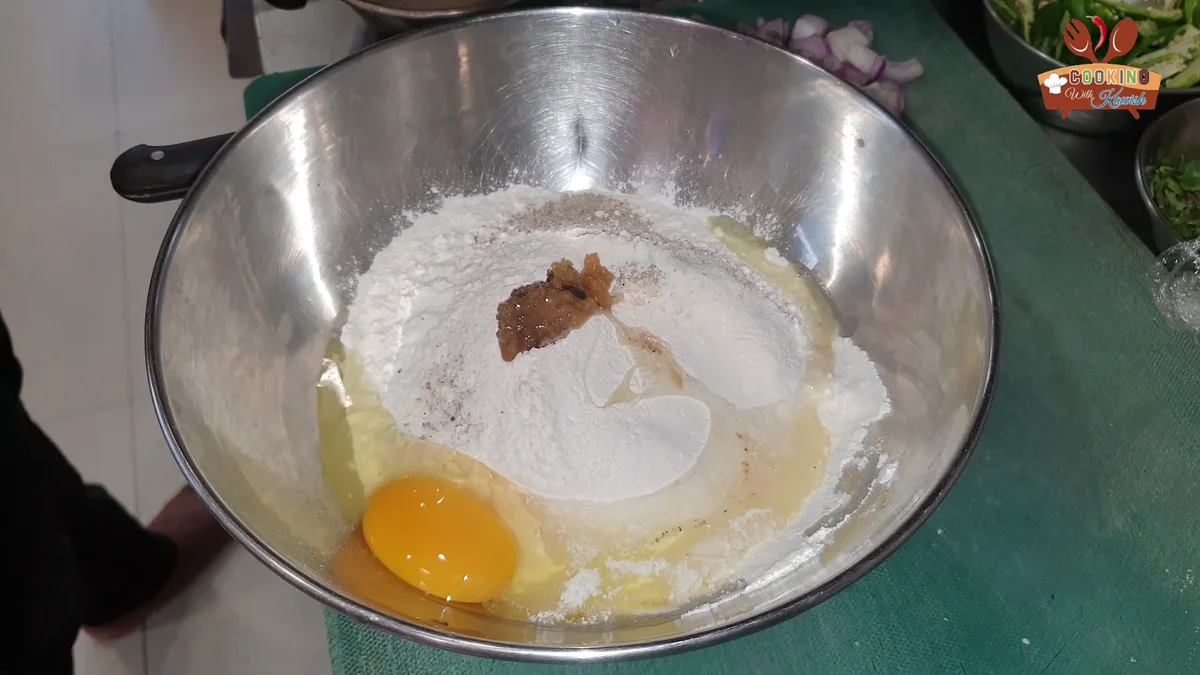 An egg cracked into the dry flour mix