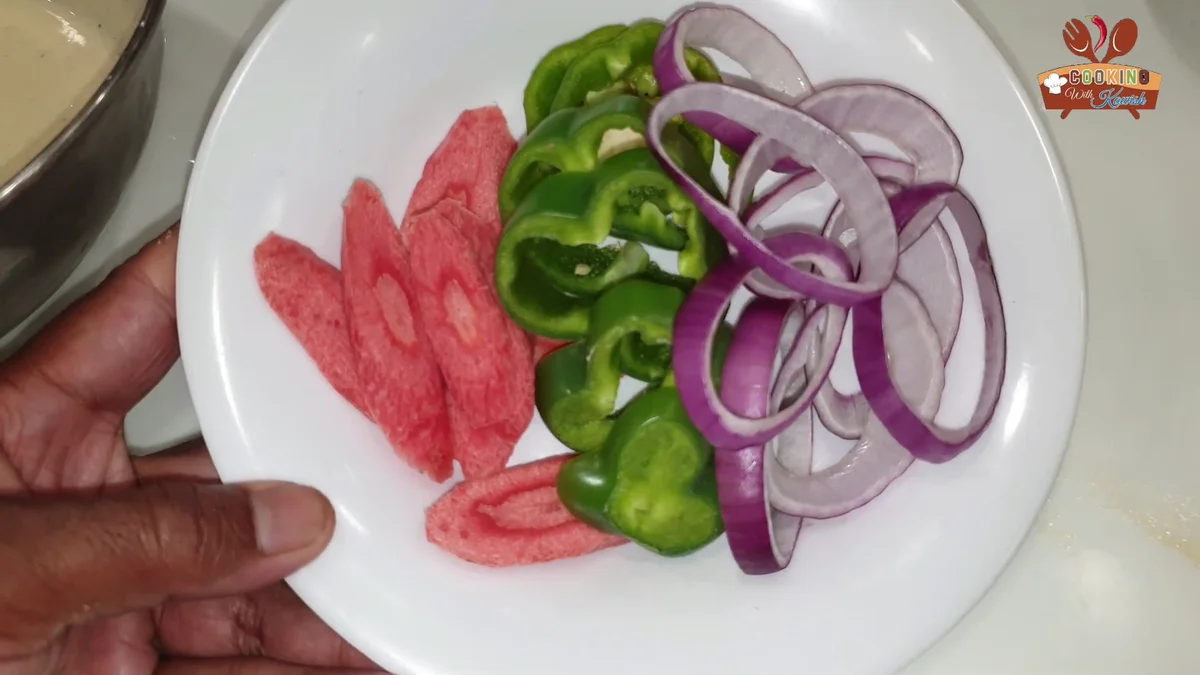 Sliced onion rings, capsicum and tomato ready for coating