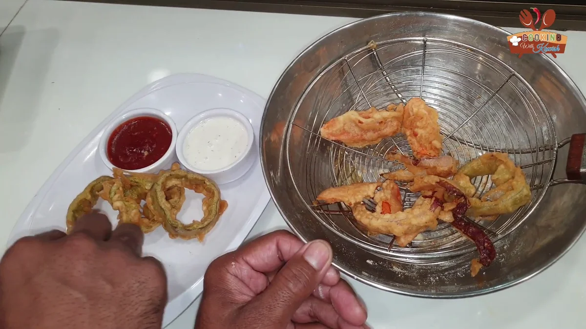 Lifting crispy tempura out of the oil in a fry basket