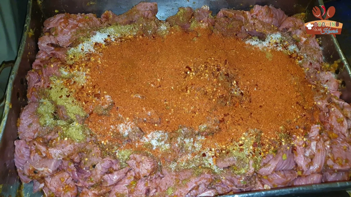 Red chilli powder spread over the Bihari boti marinade