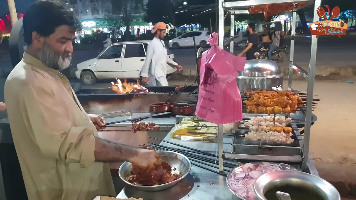 Cook threading marinated beef strips onto skewers at the stall