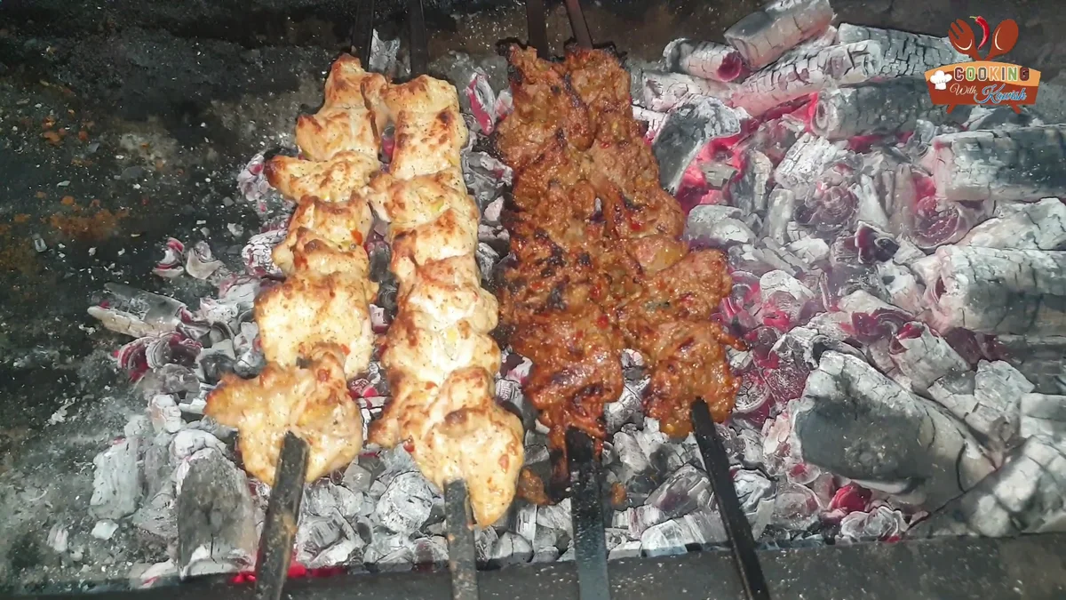 Bihari boti skewers cooking over hot charcoal