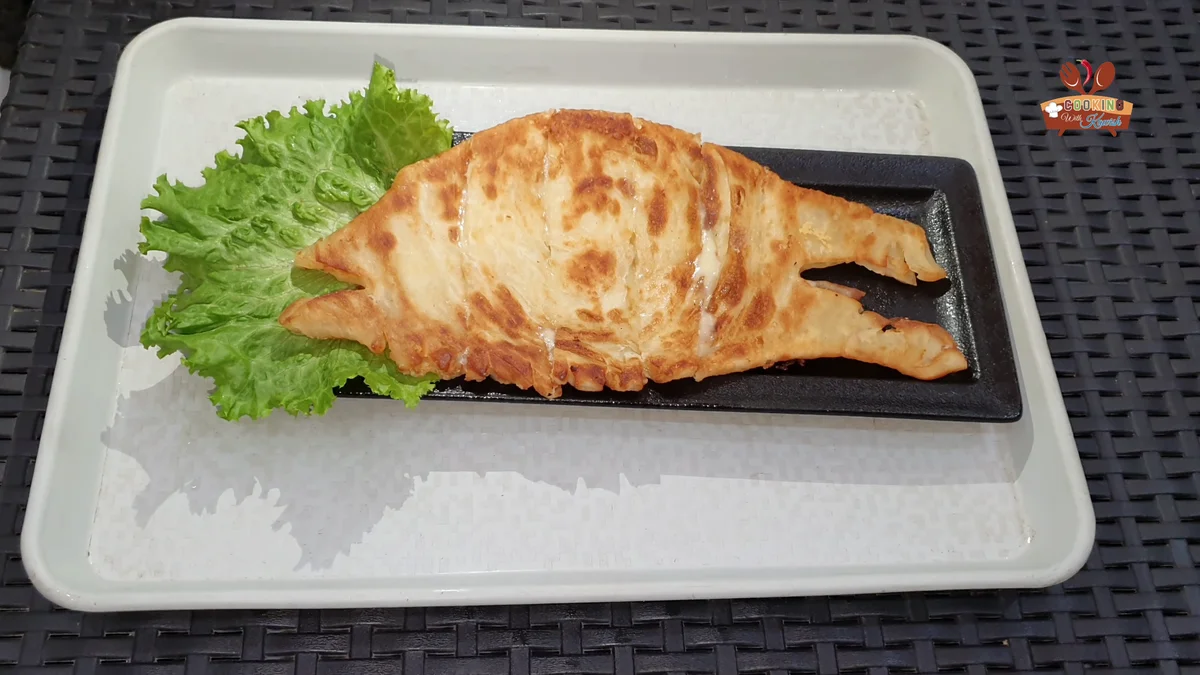 Cheese lachha paratha on a tray with lettuce