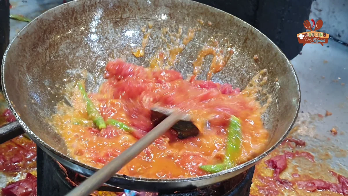 Tomatoes mashed into a gravy base in the karahi