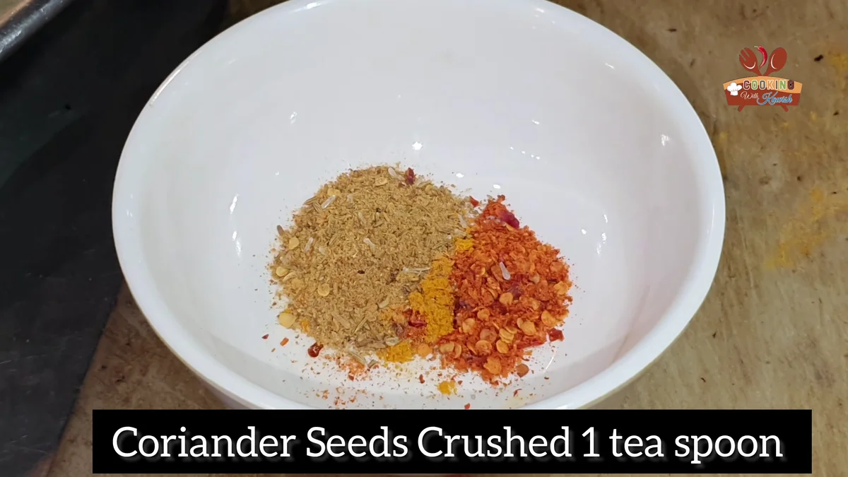 Crushed coriander seeds and red chilli flakes in a bowl