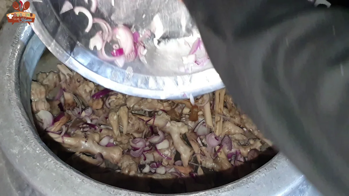 Mutton paya pieces added to the onions