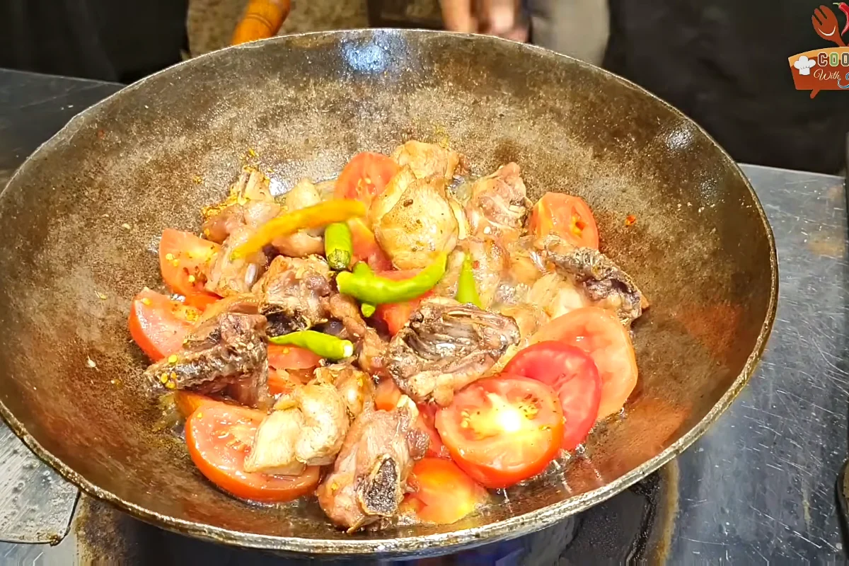 Green chillies added with tomatoes before covering