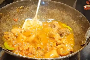 Chicken karahi masala being stirred after cumin and coriander