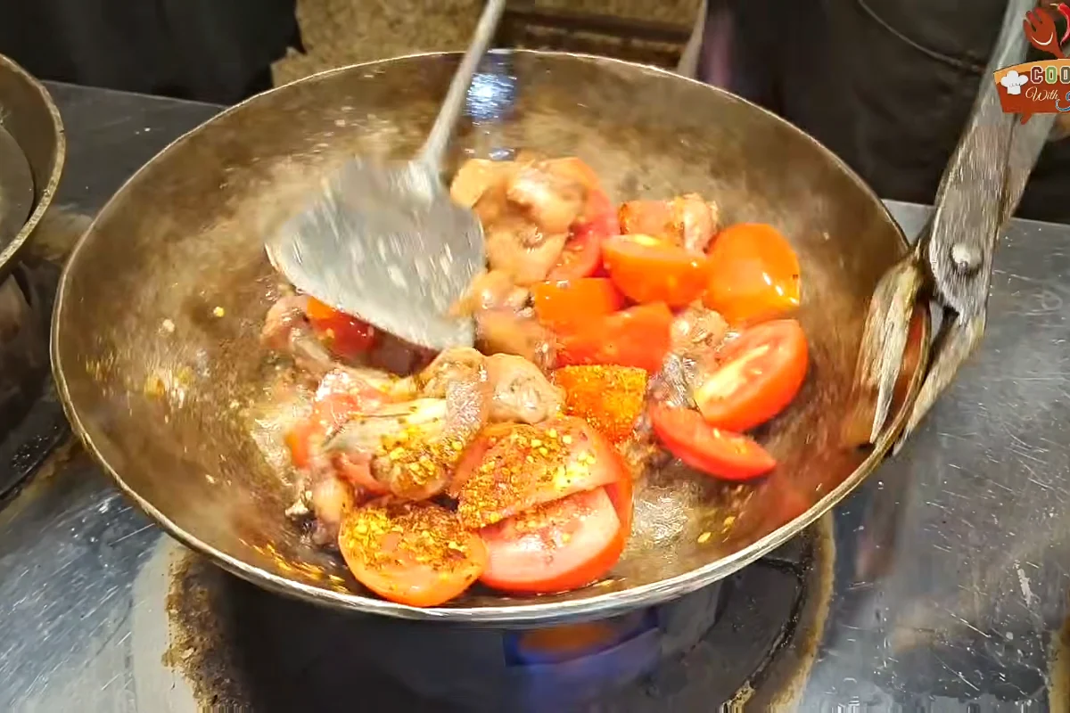 Tomatoes and red chilli flakes added to fried chicken