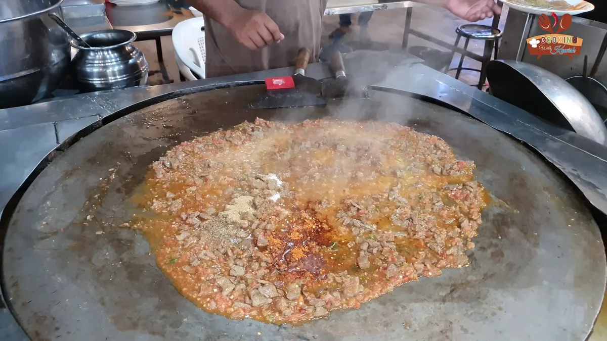 Thick red masala forming around the liver cubes