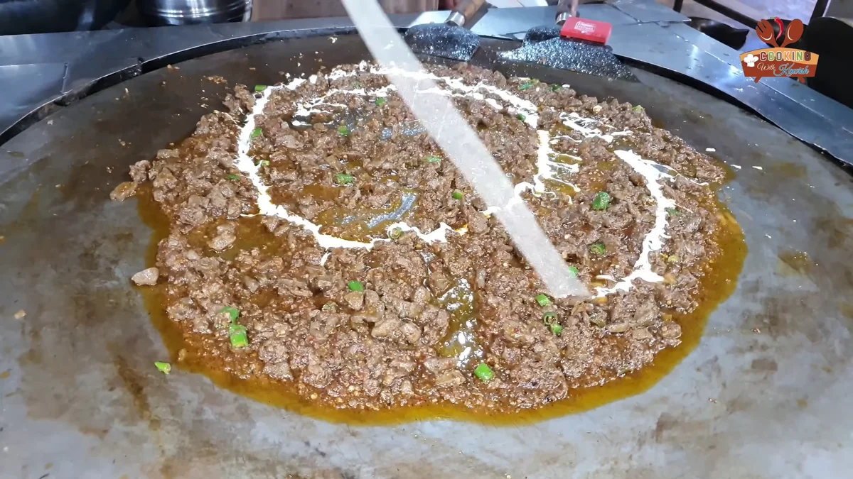 Cream drizzled over the finished tawa fry kaleji