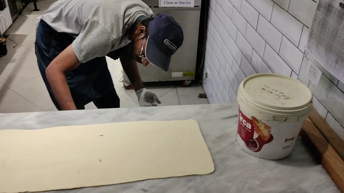 Tub of cinnamon filling next to the dough