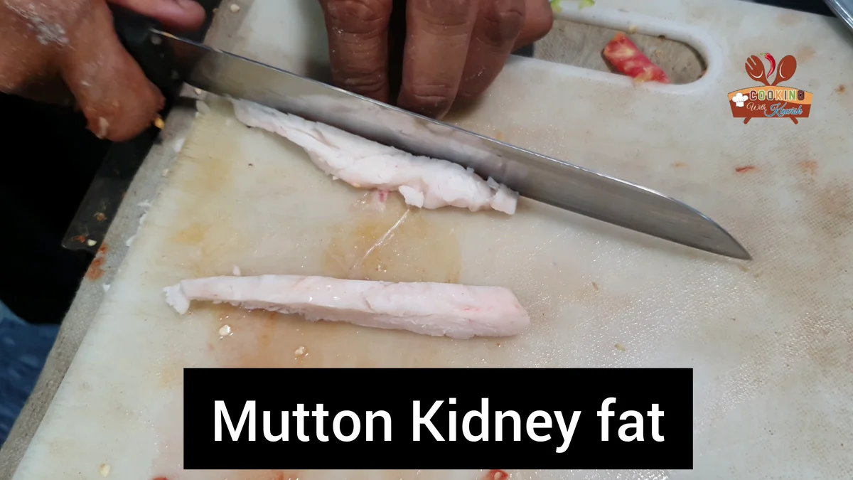 Cutting mutton kidney fat on a board