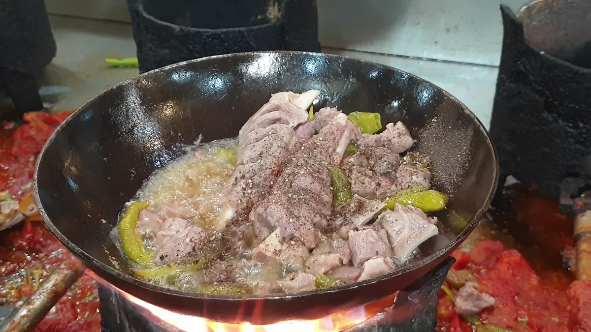 Shinwari white mutton karahi with green chillies in a wok