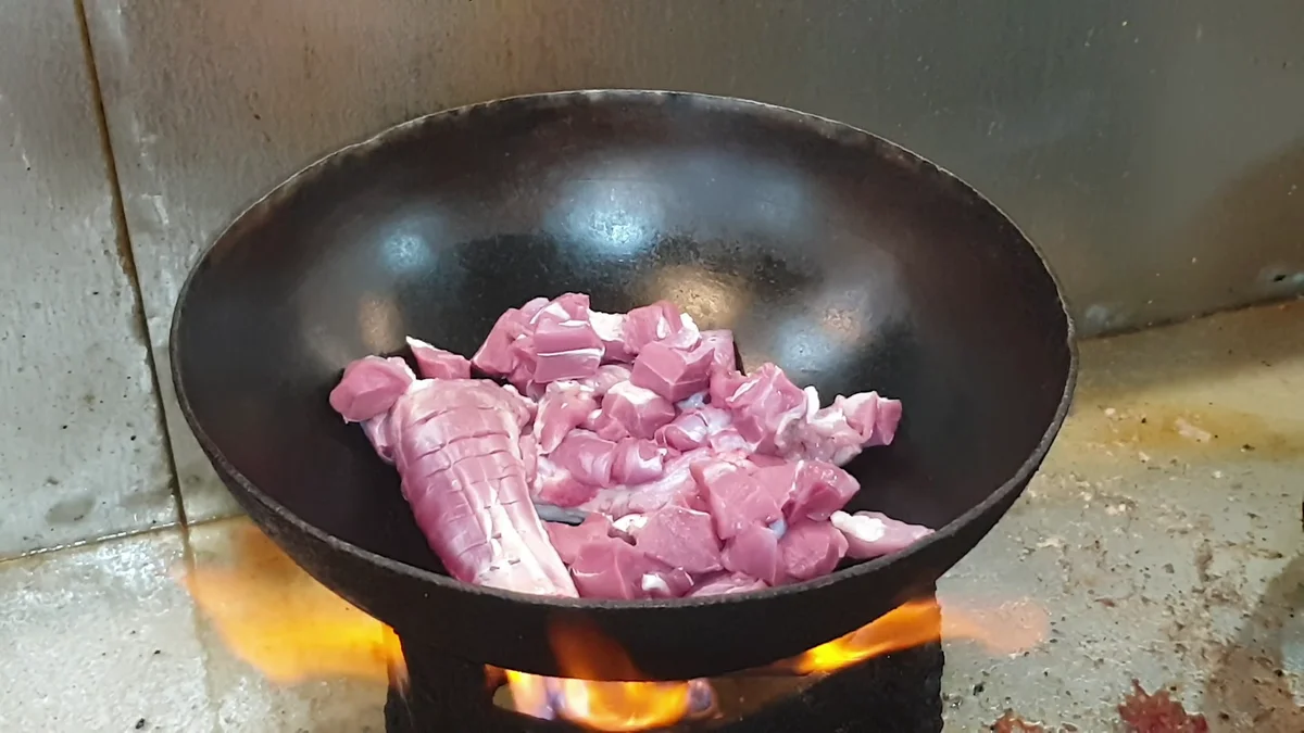 Mutton pieces in the karahi on a strong flame