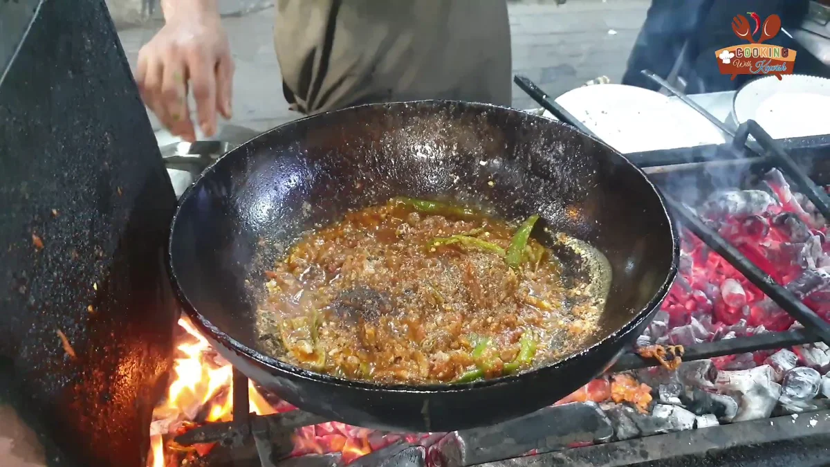 Khan Quetta fish karahi in a karahi over a fire