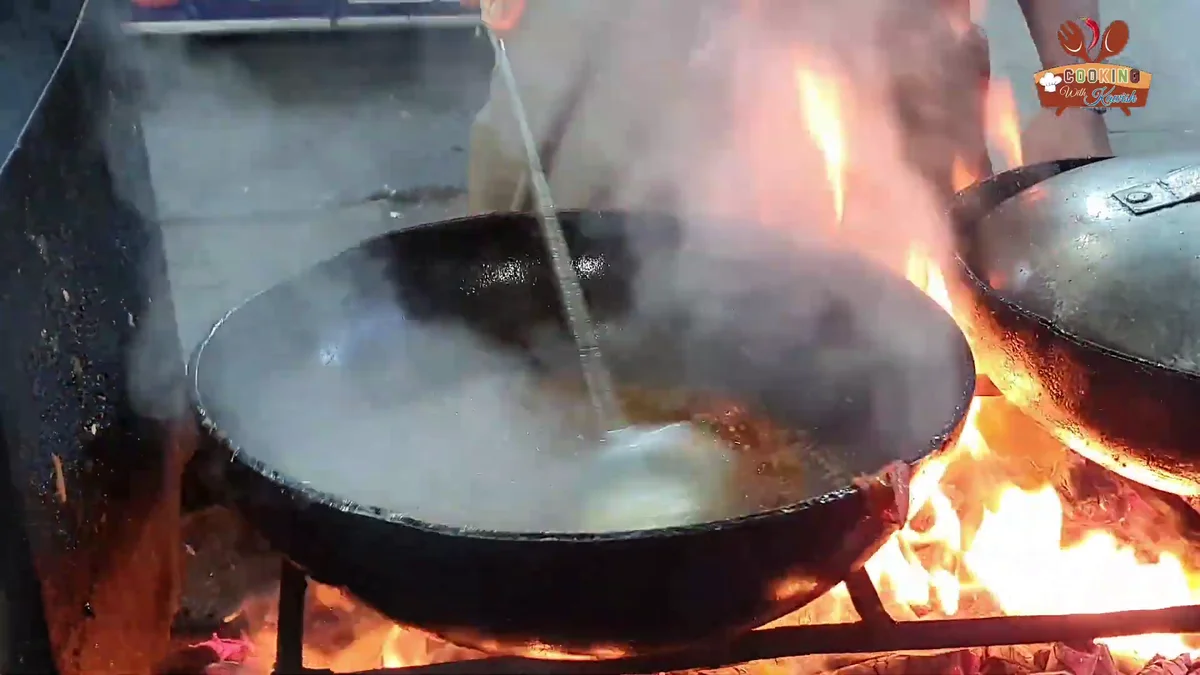 Spiced karahi gravy simmering over high flames