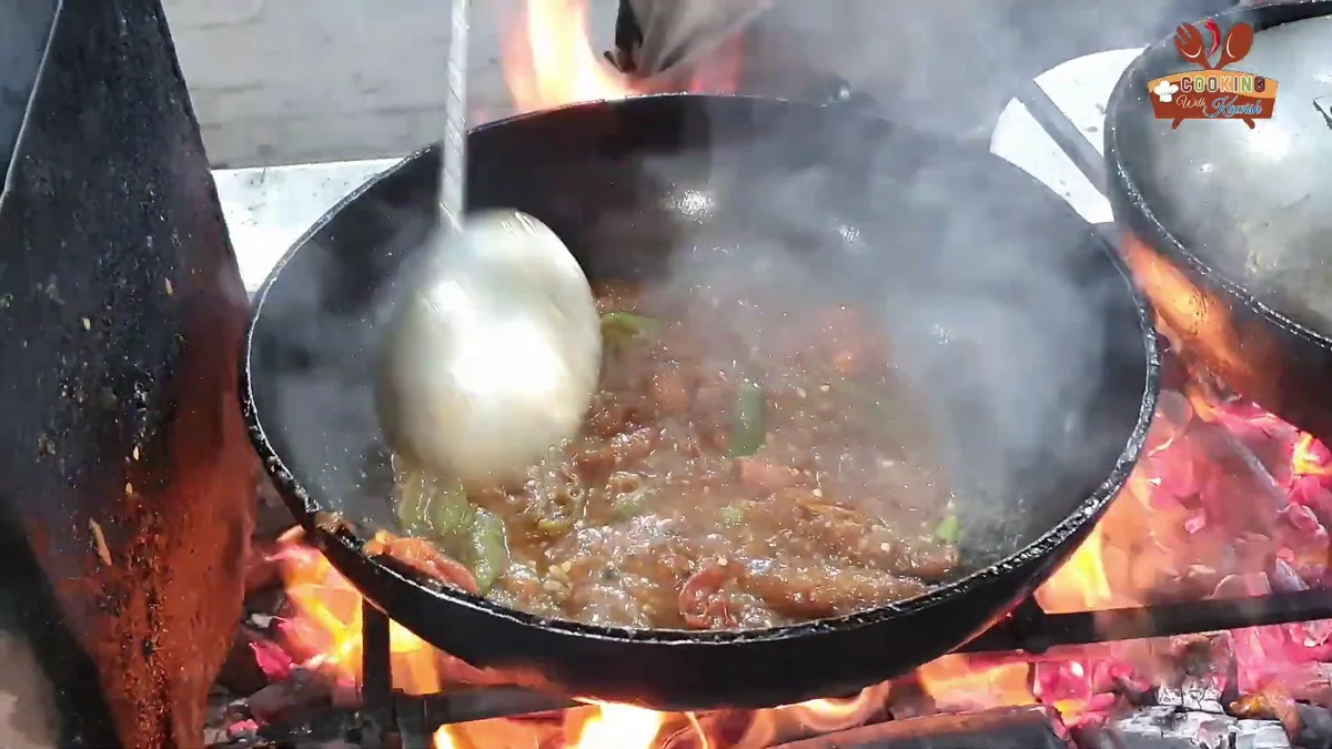 Ladling the fish karahi gravy