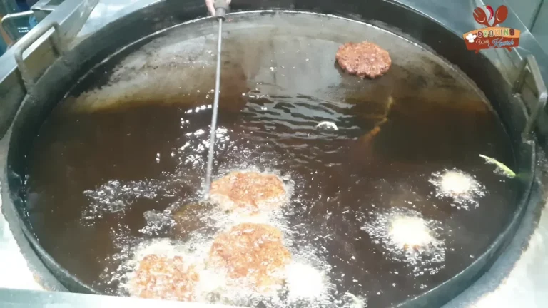 Bakra Eid chapli kababs frying in hot ghee in a wide pan