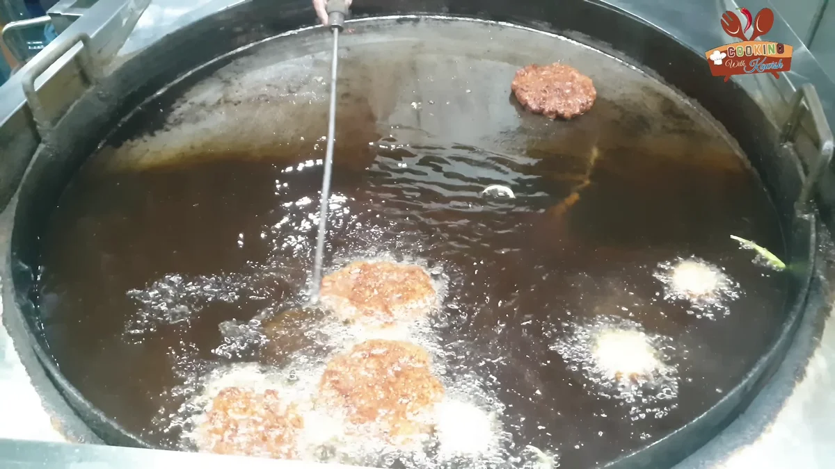 Bakra Eid chapli kababs frying in hot ghee in a wide pan