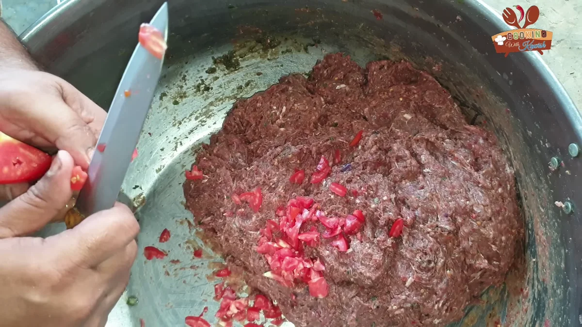 Tomatoes hand-cut into small pieces over the mince