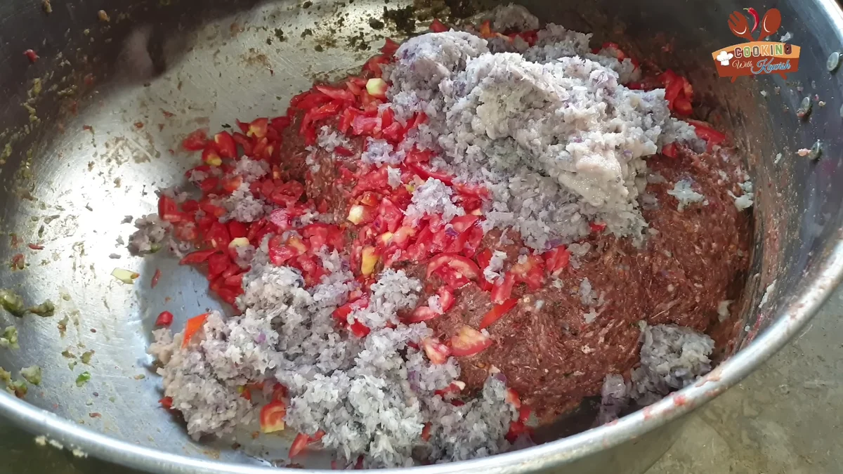 Chopped tomatoes and onion paste on top of the chapli mixture