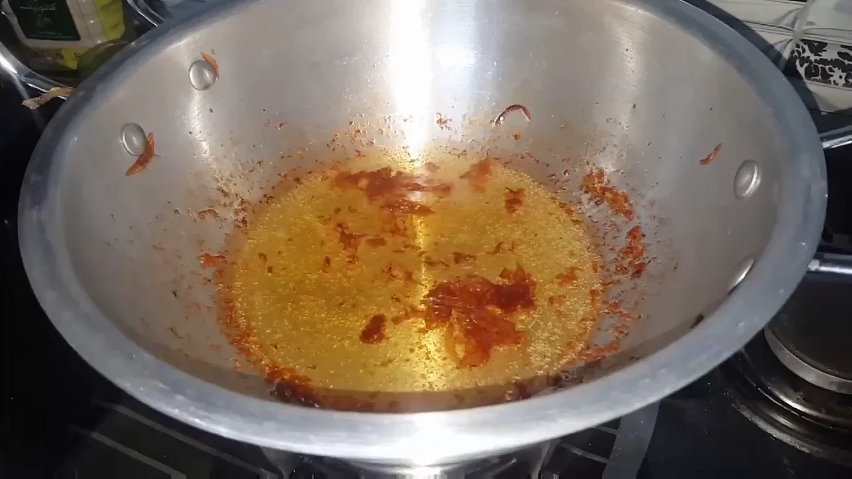 Whole spices frying in hot oil in the karahi